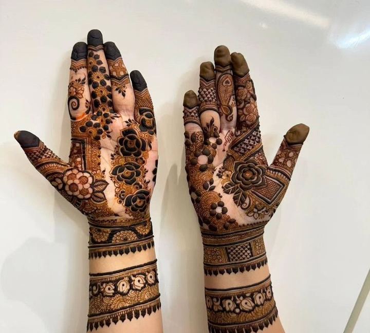 Back of hands mehendi with jaali cuffs and floral