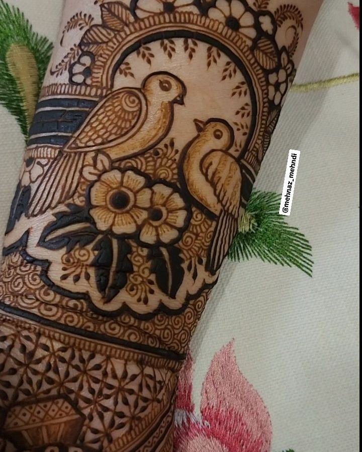 Bird and floral mehendi on back of hand
