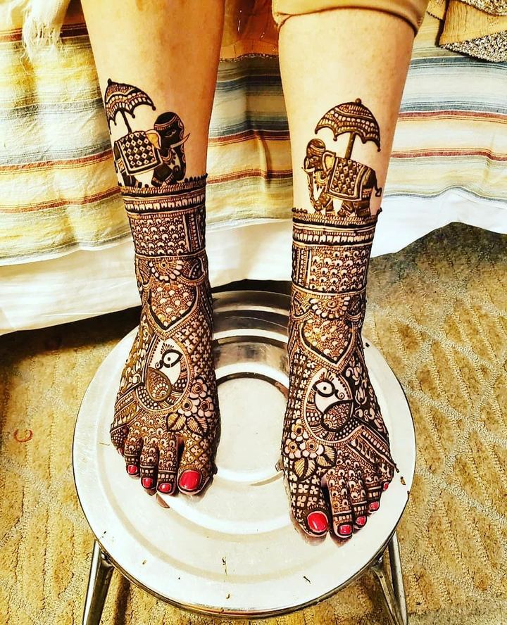 Bridal feet mehendi with doli and bride-groom portrait motifs