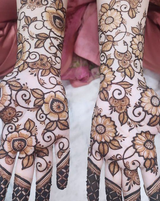Floral mehendi on both arms with pink outfit