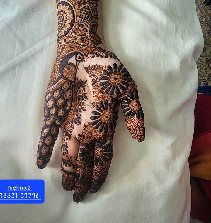Peacock bridal mehendi on palm with floral filling